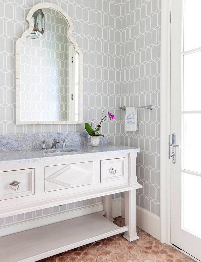 Bathroom. Bathroom features white washstand cabinet style, grey geometric wallpaper and terracotta floor tiles. #Bathroom #whitecabinet #terracotta #tile #greygeometricwallpaper Robert Elliott Custom Homes
