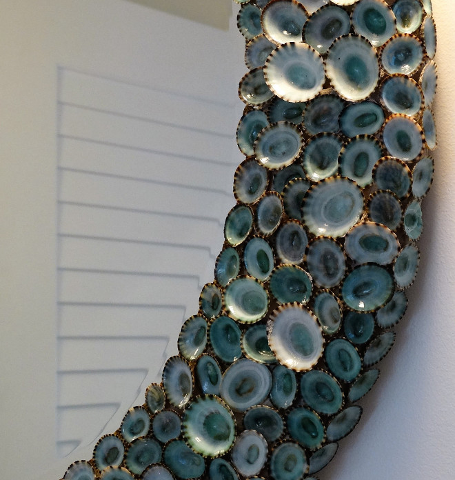 Shell Mirror. The guest bathroom features a shell mirror - Blue Limpet Shell Mirror by Karen Robertson - $1,625.00. Flagg Coastal Homes.