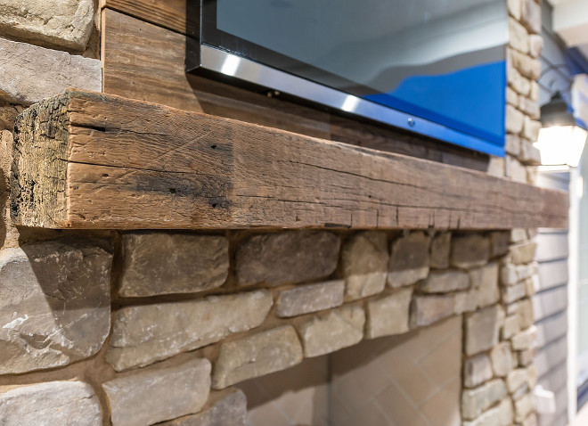 The backyard living space has a reclaimed wood accent wall above the reclaimed wood mantel. The ADDRESS Company