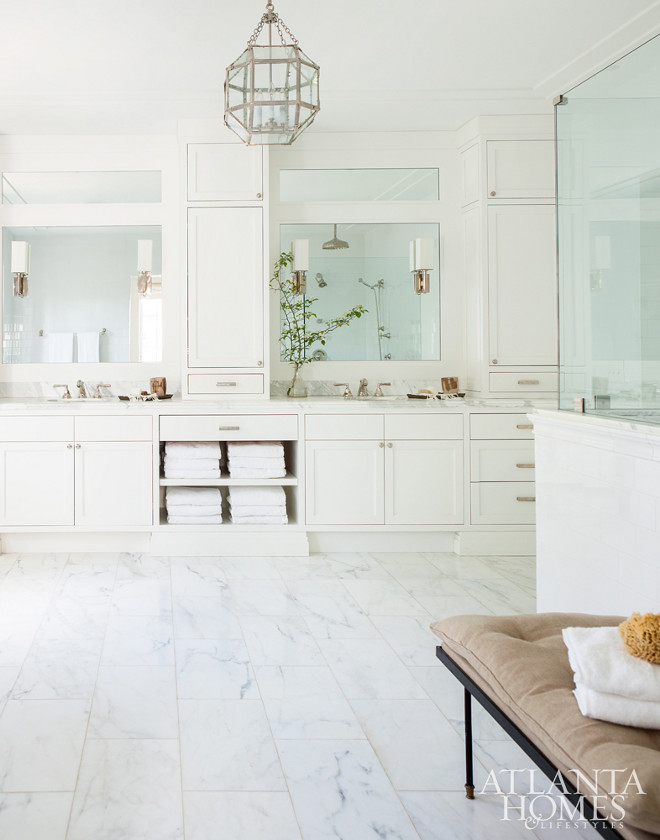 White bathroom. Off-white bathroom. Beuatiful Off-white bathroom with marble flooring, Morris pendant light and large cabinets with double sinks. #whitebathroom #offwhitebathroom #bathroom #white #morris #lighting Scout for the Home for Atlanta Homes Magazine.