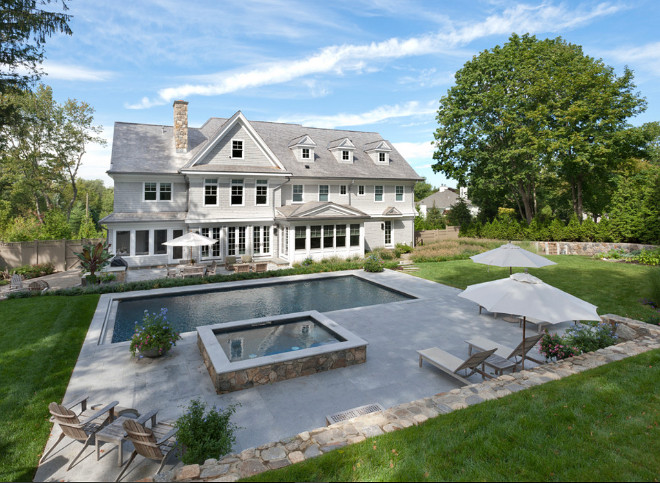 Backyard. Catering to the outdoor beach lifestyle, the house is complete with a screened porch with fieldstone fireplace, a granite patio with outdoor barbeque kitchen, spectacular landscaping and fieldstone walls with multiple areas of landscape lighting for dramatic effect at night, a gunite pool with waterfall spa and a custom water fountain and hammock, both attached and resting from hand carved reclaimed municipal building steps. #backyard Bluewater Home Buildersackyard-layout