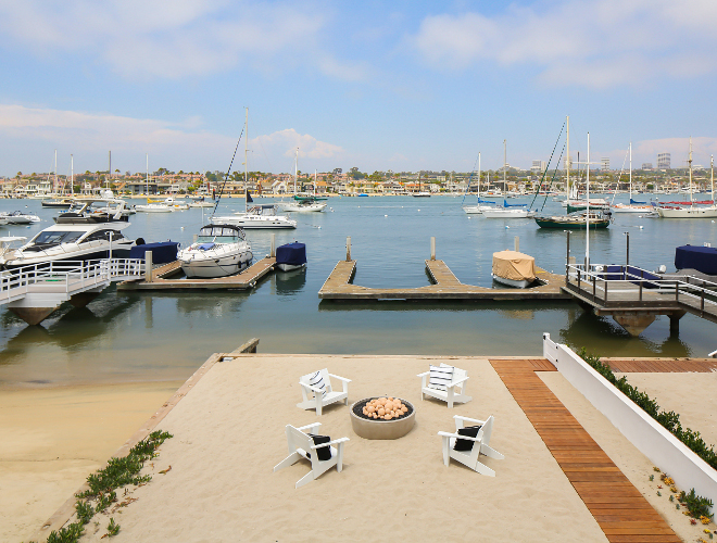 Balboa island homes. This beach house offers a rare, private backyard on the Bayfront spanning nearly 50' including patio, firepit, and a private boat slip that can accommodate a vessel of more than 50'. Winkle Custom Homes. Melissa Morgan Design. Ryan Garvin Photography