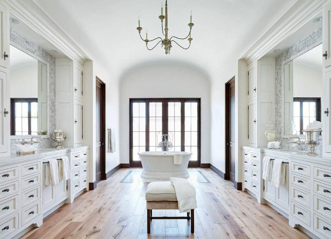 Bathroom Wood Floor: The bathroom floor is a natural wood flooring from Premiere Wood Floors. bathroom-with-lots-of-cabinets-ached-ceiling-and-reclaimed-wide-plank-hardwood-floors