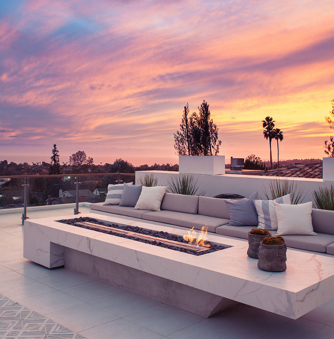 Firepit. The Firepit base is made of concrete, surrounded by a marble-looking quartz. #firepit #quartz #concrete firepit Building Solutions and Design, Inc. Photo credit: Charles-Ryan Barber Architect: Nadav Rokach