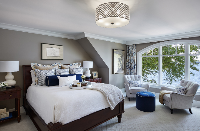 Grey master bedroom. Imagining waking up with a view like that every day. The ottoman, bedding and window treatments are all custom. Lamps are Barbara Cosgrove and the chairs are Lexington. Lighting is Quoizel. #bedroom #greybedroom Vivid Interior Design. Hendel Homesgrey-master-bedroom