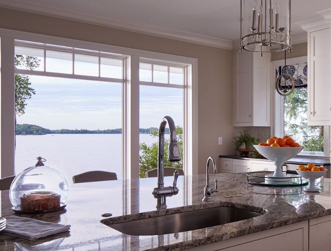 Kitchen island. The kitchen island features a white and gray granite countertop; Serenity Granite. Kitchen faucet is Victorian Pull-Down Kitchen Faucet by DXV. Sink is by Blanco. #kitchenisland #faucet #countertop #sinkkitchen-faucet Vivid Interior Design. Hendel Homes