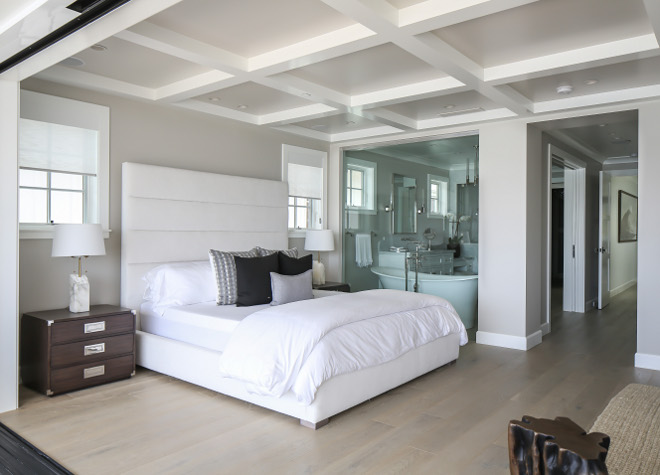 Master Bedroom with open bathroom. Glass separates the tub from the master bedroom allowing natural light to the bathroom. Winkle Custom Homes. Melissa Morgan Design. Ryan Garvin Photography