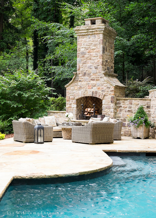 Outdoor pool patio fireplace. Outdoor fireplace placed on pool patio. Pool patio fireplace. Enchanting outdoor area with pool, patio and outdoor fireplace. #Outdoors #Outdoorfireplace #pool #patio Liz Williams Interiors