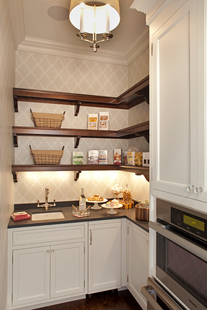 Pantry. Kitchen pantry. Butlers pantry This is a small but very functional pantry. Cabinets are painted in Benjamin Moore Icicle 2142-70. Wallpaper is Thibaut Stanbury Trellis and the open shelves are Cherry wood in a custom stain. #pantry #smallpantry #pantry #butlerspantry Vivid Interior Design. Hendel Homes