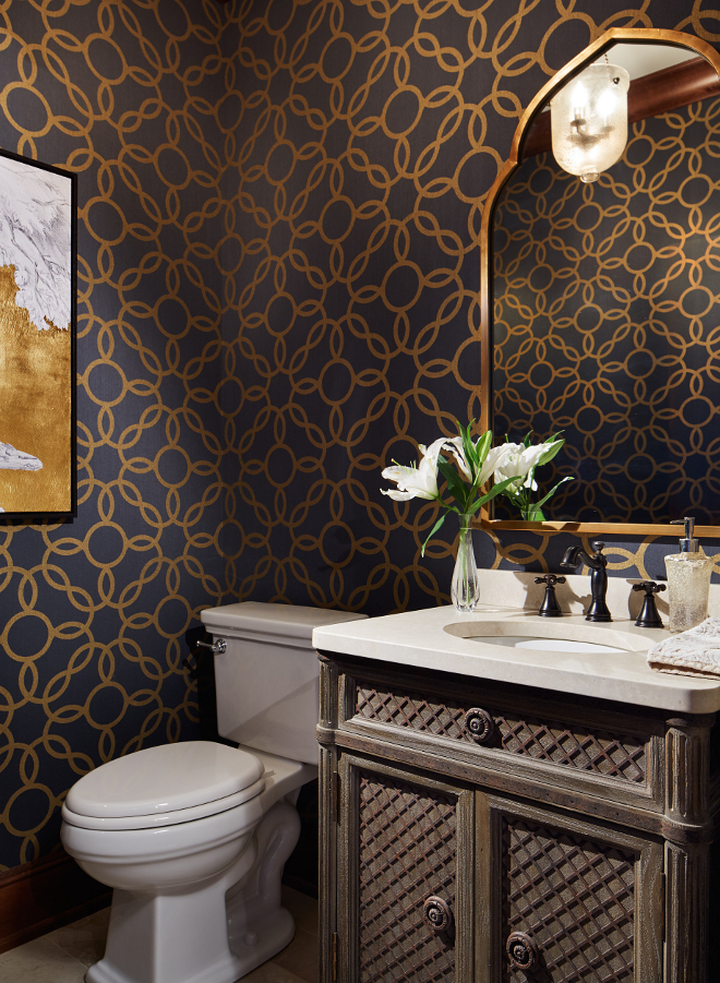 Powder room. The powder room features a gorgeous navy and metallic gold wallpaper by Phillip Jeffries. #powderroom #wallpaper #navywallpaper #metallic powder-room Vivid Interior Design. Hendel Homes