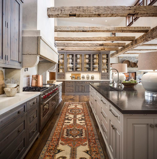 Rustic Kitchen. Rustic kitchen with reclaimed beams, stained rustic cabinets and soft gray island. Rustic kitchen runner. Rustic Kitchen #RusticKitchen #Kitchen Tiffany Farha Design