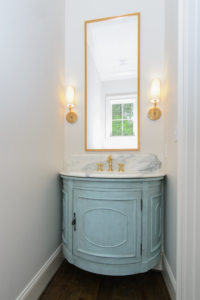 Bathroom Blue Cabinet Paint Color. Turquoise Blue Half Moon Floating Washstand with Tall Brass Mirror. I asked the designer about the color used on this bathroom cabinet and I was very surprised with what she told me about this cabinet. What a brilliant idea! "Actually, this is not a custom piece, this was the Tucci cabinet by SteinWorld found on Wayfair for $569.99! Since this was going in a speculative build, I wanted to maximize investment dollars. Our cabinet maker wanted to charge over $3,000 for a demilune design, so this was used instead". Isn't she smart?! Bathroom Blue Cabinet Paint Color. Bathroom Blue Cabinet Paint Color #Bathroom #BlueCabinet #PaintColor bathroom-blue-cabinet-paint-color Tasha B. Davis Interiors, LLC.