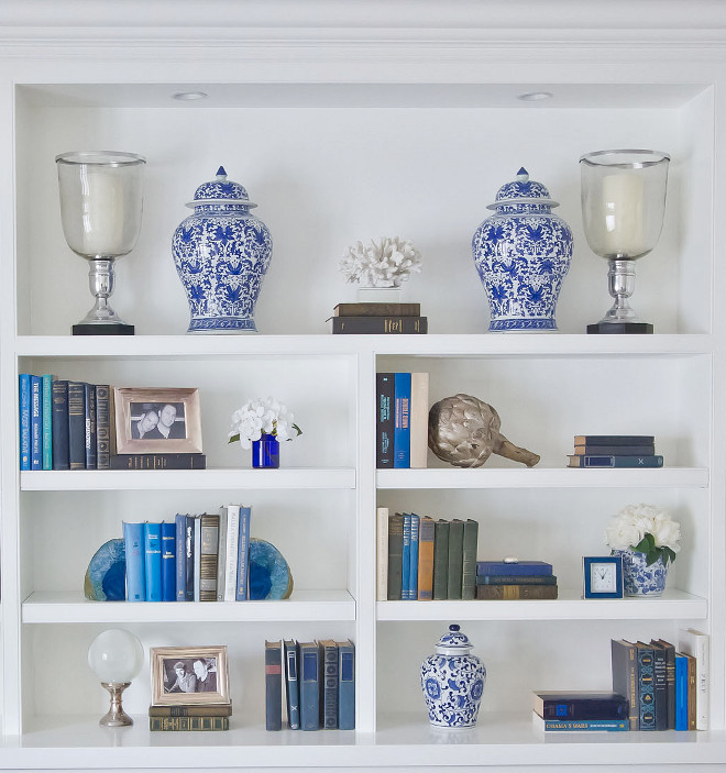 Blue and white bookshelf styling. The custom built-ins you see serve as a kind of accessory wall for us. We love the elegant Japanese Ginger jars, accentuated with smaller complementary items in neutral hues. The built-in color is Benjamin Moore Simply White. #Bookshelf #blueandwhiteblookshelf #benjaminmooresimplywhite Home Bunch Beautiful Homes of Instagram Bryan Shap @realbryansharpblue-and-white-bookshelf-styling