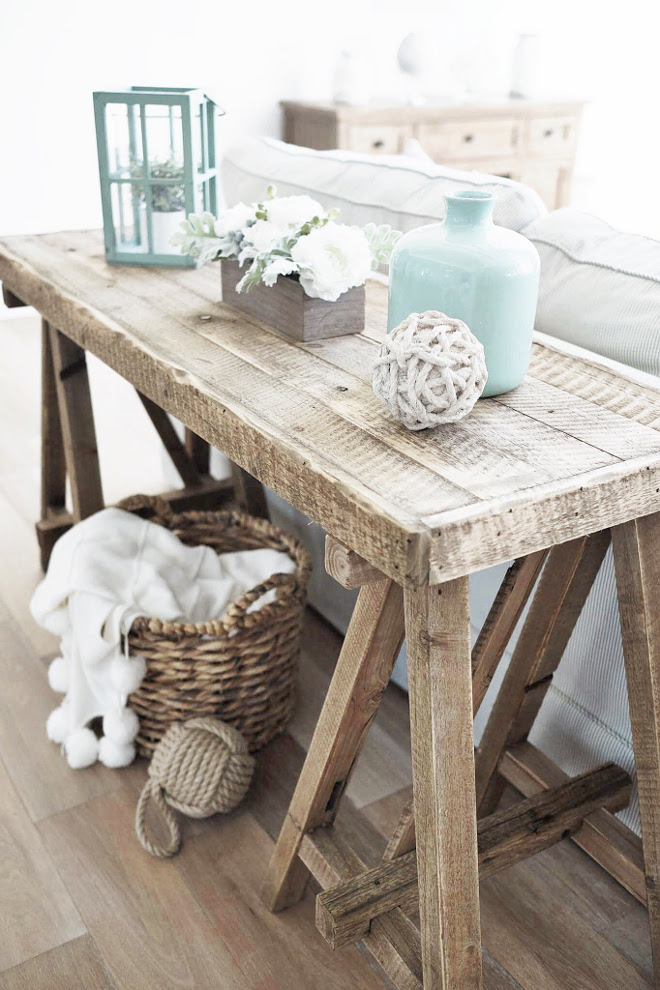 Sofa table. Farmhouse, rustic sofa table. You can have a sofa table even if you don't have floor outlets. Instead of using lamps, add one lantern (or a pair) and a vase. Remember to keep it symmetrical. #sofatable #sofatabledecor #homedecor #interiors Beautiful Homes of Instagram @nc_homedesign via Home Bunch