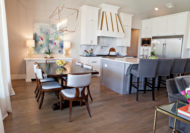 Kitchen and dining area. The dining area is just off the kitchen and the homeowners wanted to keep their current dining table, so the designers found chairs that really accents the space. They added a low profile chair, to keep the space open and minimal. #kitchen #diningarea kitchen-and-dining-area Ivy House Interiors