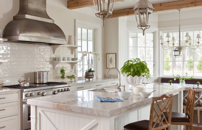 White Beadboard Kitchen Island . White Beadboard Kitchen Island with Faux Bamboo Counter Stools. A pair of vintage gA pair of vintage gray lanterns hang over a white kitchen island accented with beadboard trim topped with gray quartzite fitted with a sink and gooseneck faucet lined with faux bamboo counter stools. A dark steel dome kitchen hood stands over a stainless steel stove flanked by stacked white shelves accented with corbels.ray lanterns hang over a white kitchen island accented with beadboard trim topped with gray quartzite fitted with a sink and gooseneck faucet lined with faux bamboo counter stools. A dark steel dome kitchen hood stands over a stainless steel stove flanked by stacked white shelves accented with corbels. White Beadboard Kitchen Island #WhiteBeadboard #KitchenIsland Ryland Witt Interior Design