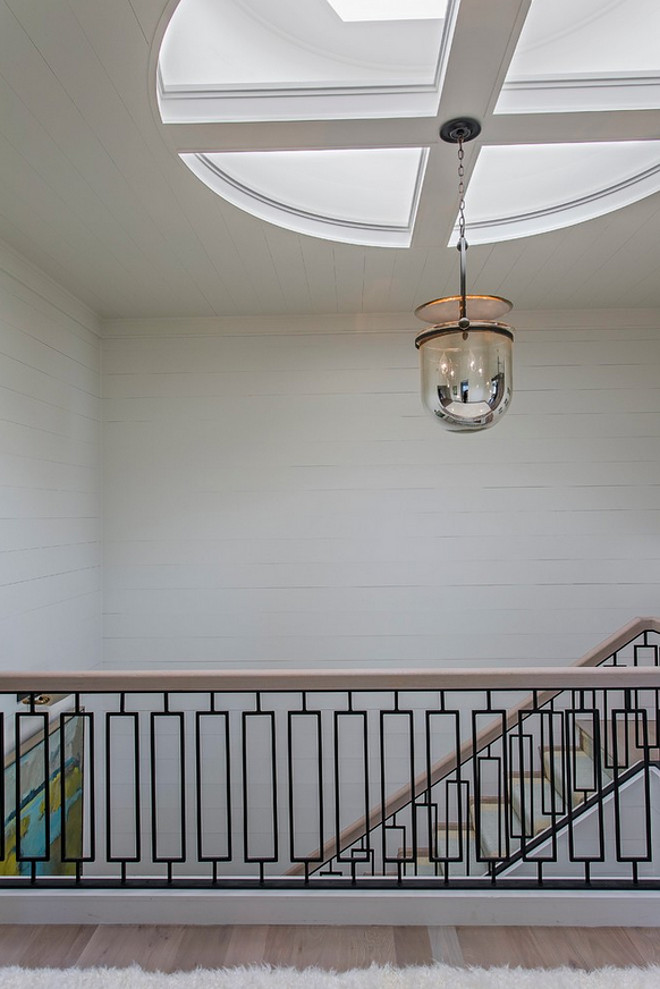 Urban Electric Smokebell Pendant. The staircase features a beautifully designed custom railing. Lighting is Urban Electric Smokebell Pendant. #UrbanElectric #SmokebellPendant Herlong & Associates Architects + Interiors