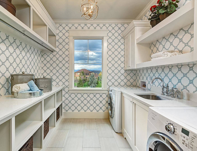 Laundry Room. Laundry room features neutral floor tile, off-white cabinets with crystal knobs and white quartz countertop. Laundry room also features a blue and white trellis wallpaper. laundry-room