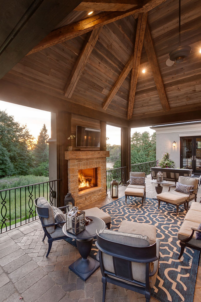 Reclaimed wood ceiling. The outdoor porch features reclaimed wood ceiling and an outdoor fan. The outdoor fan is Heritage - 60" Model: C19500K. #Reclaimedwoodceiling #outdoorfan reclaimed-wood-ceiling Hendel Homes