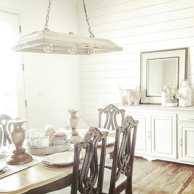 Farmhouse dining room. The farmhouse dining room features an old cabinet, painted in a soft gray by the homeowners, and shiplap walls. The rustic dining room chandelier is from Painted Fox. rustic-farmhouse-dining-room-with-shiplap-walls #farmhouse #Farmhousediningroom #diningroom #shiplap #rustic Home Bunch's Beautiful Homes of Instagram ourfarmhousefit