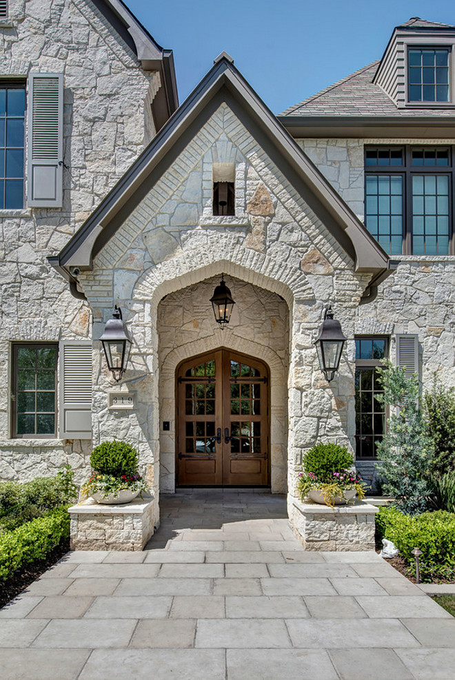 Exteriro stone. The exterior stone is a full 4" limestone quarried in Oklahoma, sold locally by Alamo Stone. Their in-house name is Alamo White Ledgestone. #exteriorstone #exterior #stone Allan Edwards Builder Incstone-exterior-with-wood-front-door