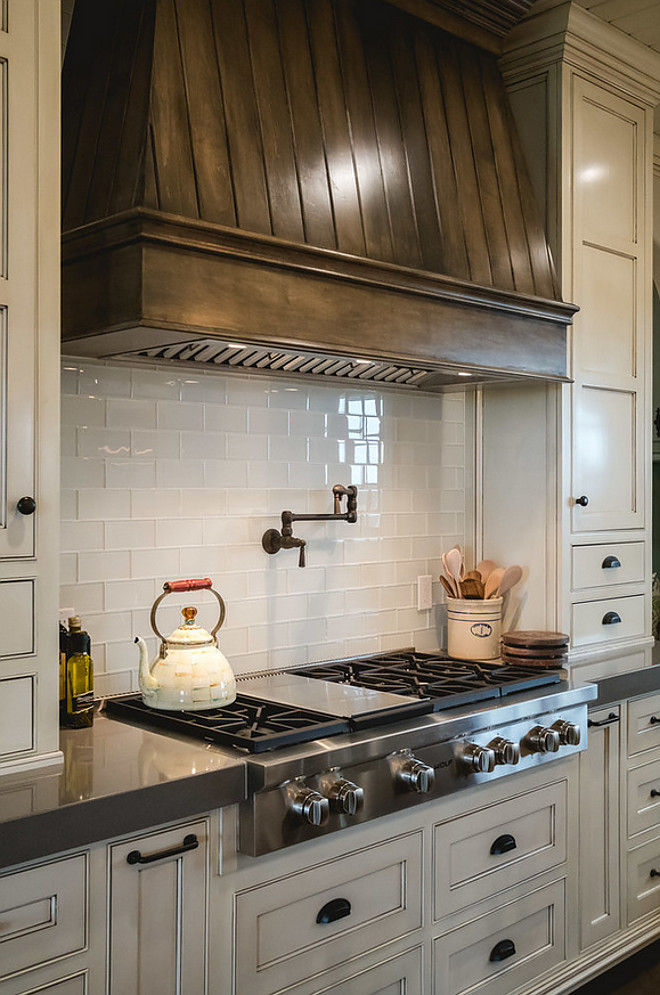 Kitchen features Tobacco stained kitchen hood, creamy white cabinets and grey quartz countertop. tabacco-stained-kitchen-hood-and-creamy-white-cabinets Alicia Zupan