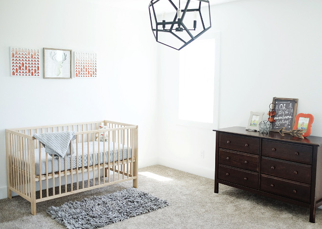 Transitional nursery. For this room, I wanted it to be more outdoorsy with different tones of brown, a few gray tones, and accents of orange. Paint color is Sherwin Williams Extra White. Crib is Ikea and the light fixture is RH Baby & Child. Beautiful Homes of Instagram @nc_homedesign via Home Bunch