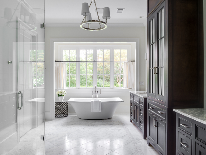 Serene bathroom. The master bathroom is serene and bright, just like every other space in this home. Countertops are calacutta. Tub is Escale by Kohler. #bathroom #serenebathroom Interiors by Courtney Dickey. Architecture by T.S. Adam Studio.
