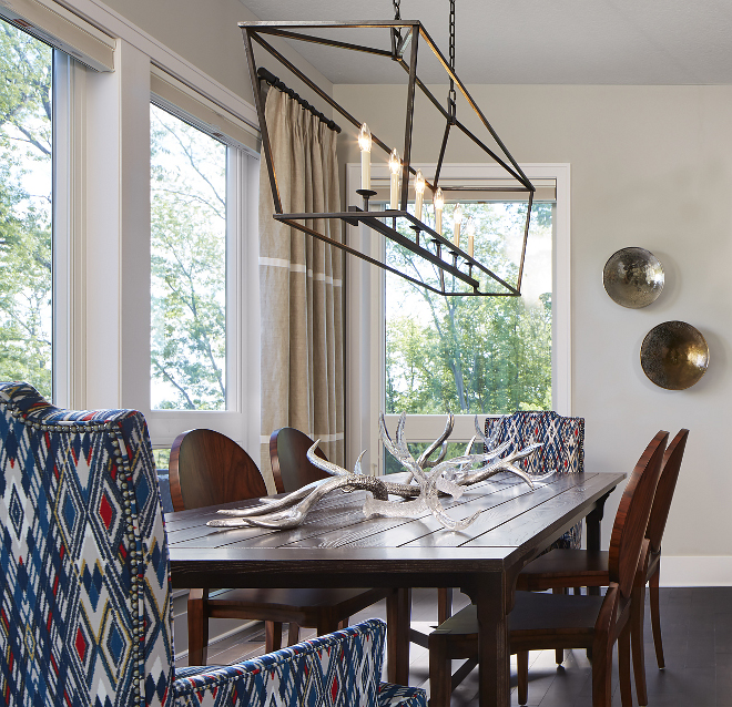 Darlana Linear Pendant CHC2166 in Aged Iron. Beautifully decorated, this dining room feature floor-to-ceiling windows and a liner chandelier over the table. Linear chandelier is Darlana Linear Pendant CHC2166 in Aged Iron #DarlanaLinearPendant #DarlanaLinearPendant CHC2166 #AgedIron#DarlanaLinearPendant Vivid Interior Design