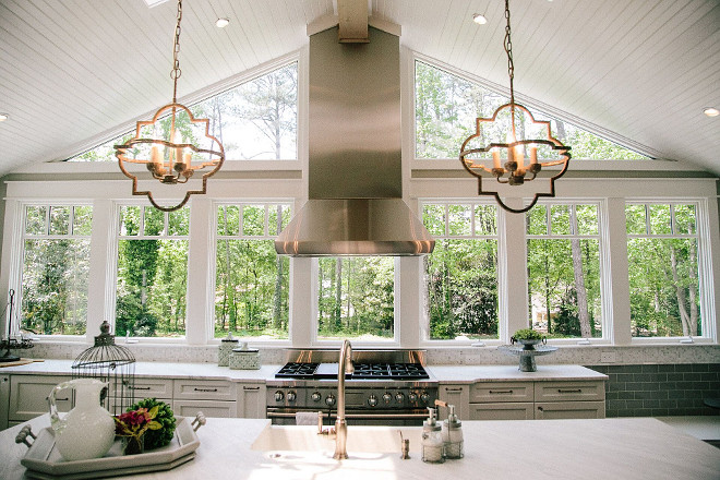 Kitchen windows. Carrera honed marble mosaic tile and windows play as "backsplash" in this kitchen. #kitchenwindows #backsplash #kitchen #window Outrageous Interiors