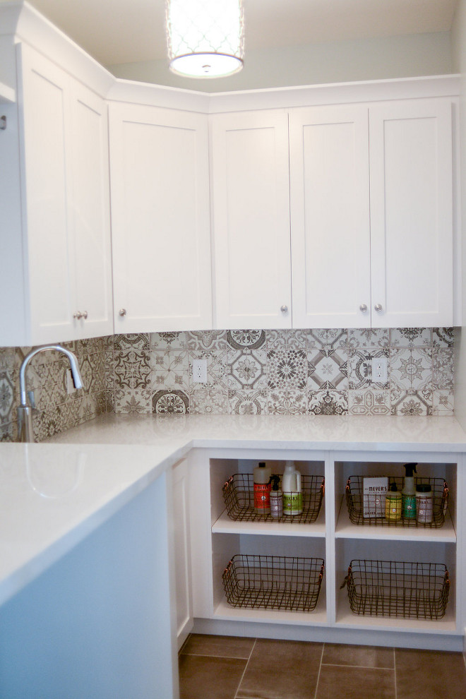 It's great to add a little of personality in small spaces such as laundry rooms. This one features white quartz countertop and patterned cement tiles for backplash. Countertop is Lyskamm Quartz. Flooring: Reside 12x24 Ash Semi-polished, 12”x24”, brick layout. Laundry room paint color is General Paint Norquay CL 3081. Millhaven Homes