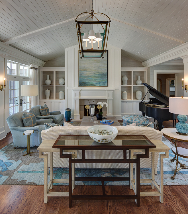 Shiplap vaulted ceiling. The living room design incorporates a shiplap ceiling and a relaxed lounge area with sophisticated accents in upholstery, lighting, and accessories. Layering breezy blues and crisp creams against classic English arm chairs and a textured chenille sofa, a casual elegance is brought to this space. #shiplap #vaulted #ceiling #shiplapceiling shiplap-vaulted-ceiling W Design