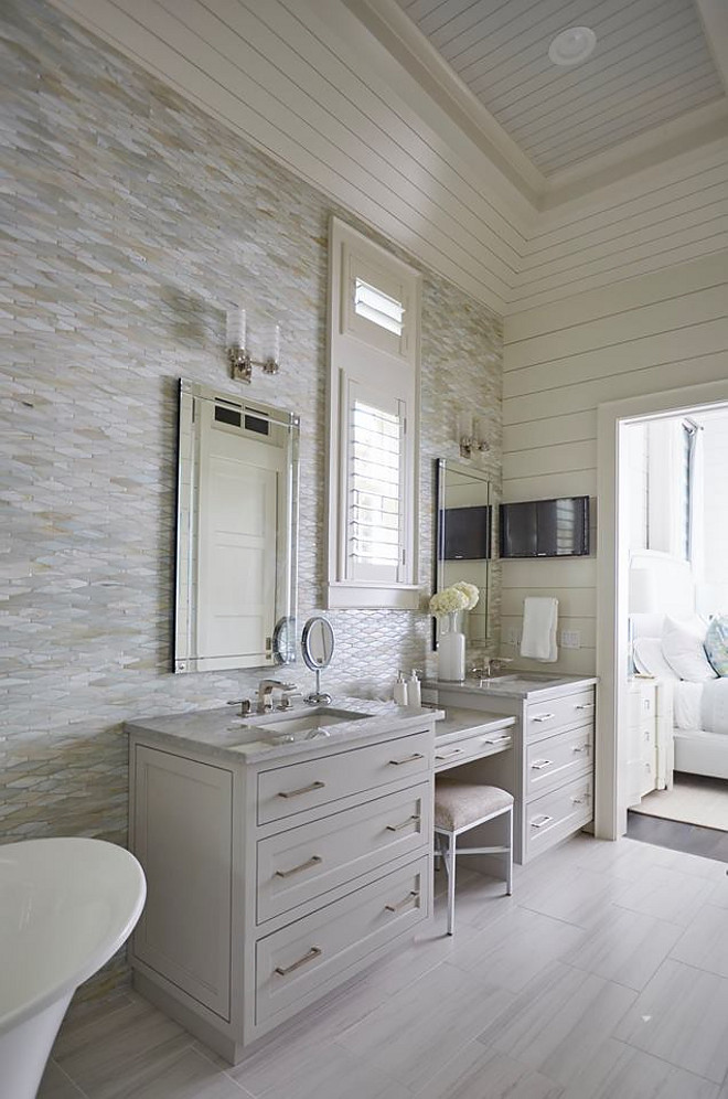 Oblong Marble Tile Wall. Bathroom features Oblong Marble Tile and shiplap walls. This master bathroom features an oblong marble tile accent wall, neutral floor tiles and light gray his and her washstands flanked by a drop down makeup vanity. Vanity paint color is similar to Benjamin Moore OC-52 Gray Owl. shiplap-bathroom-with-tile-accent-wall