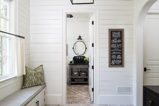 Farmhouse shiplap mudroom. Farmhouse mudroom. The mudroom features shiplap walls and a window seat. Cushion is in an indoor/ outdoor fabric. #shiplap #farmhouse #mudroom #farmhousemudroom shiplap-mudroom-with-bathroom Interiors by Courtney Dickey. Architecture by T.S. Adam Studio.