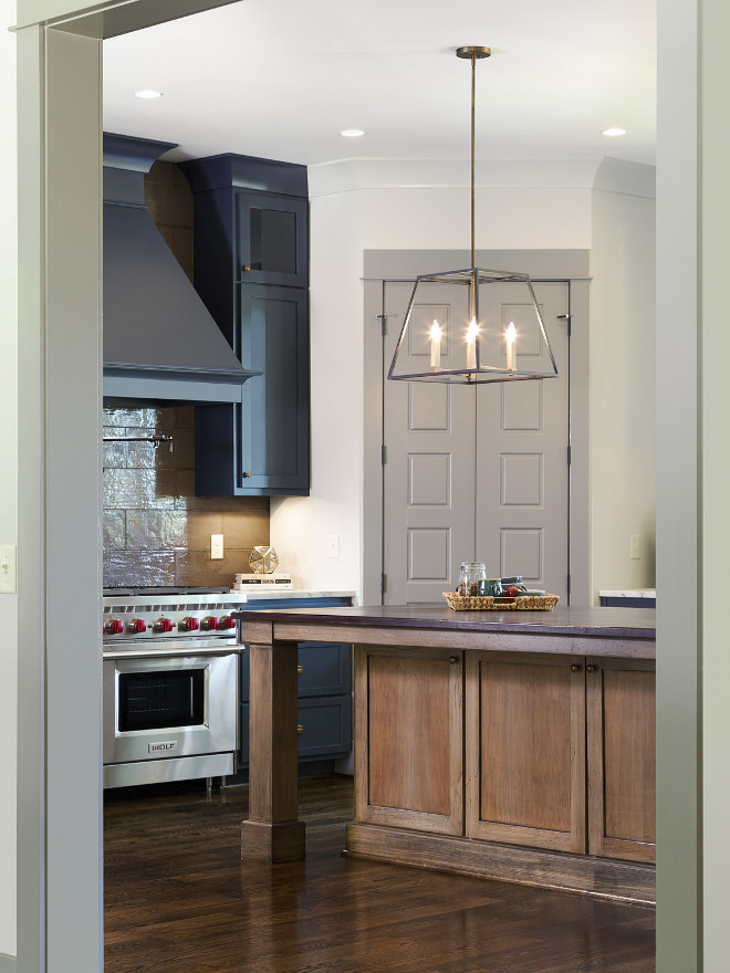 The wall color is Agreeable Gray by Sherwin Williams and the pantry door is Dovetail by Sherwin Williams. Willow Homes