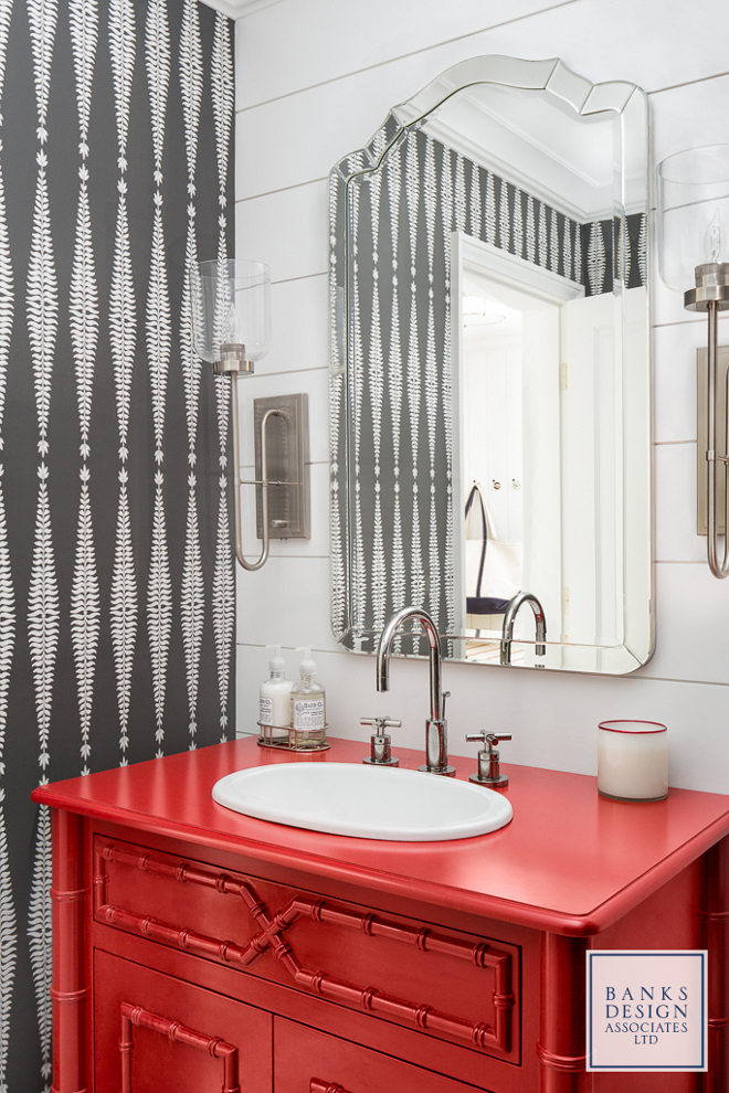 Heritage Red by Benjamin Moore. This powder room mixes elements in a very intriguing way - a hand-screened wallpaper in white and charcoal plays against shiplap accent wall while a red bamboo vanity carries the color palette of the house to this space. Red vanity paint color is paint color is Heritage Red by Benjamin Moore. #HeritageRedBenjaminMoore Banks Design Associates, LTD & Simply Home