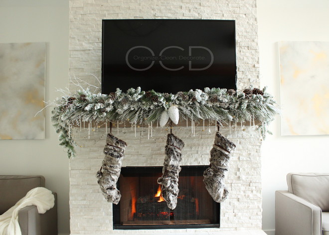 The neutral Christmas decor complements the white stone and the chunky wood mantel. Beautiful Homes of Instagram organizecleandecorate