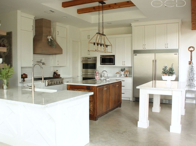 Farmhouse Kitchen. Farmhouse Kitchen. This farmhouse kitchen is truly a dream! I love the double islands and the cedar hood. Farmhouse Kitchen. Beautiful Farmhouse Kitchen with white cabinets and concrete flooring. <Farmhouse Kitchen> #FarmhouseKitchen Beautiful Homes of Instagram organizecleandecorate
