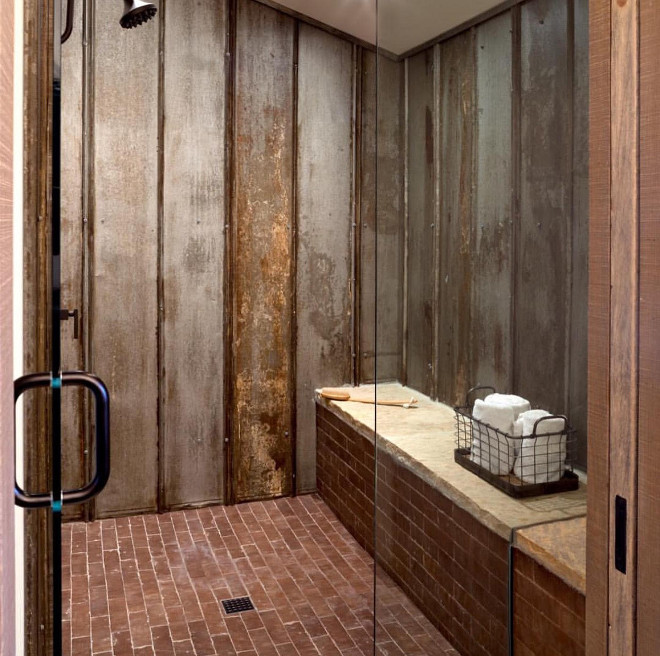 Rustic Shower. Rustic Bathroom shower. Reclaimed tin roof v-chanel material lines the shower walls. Ceramic "brick" tile adds to the rustic appeal with ultimate durability. Floor Tile: Daltile union square, cobble brown. Shower Bench Stone: Torreon tumbled stone. #rusticshower #rusticbathroom #shower Home Bunch's Beautiful Homes of Instagram @birdie_farm