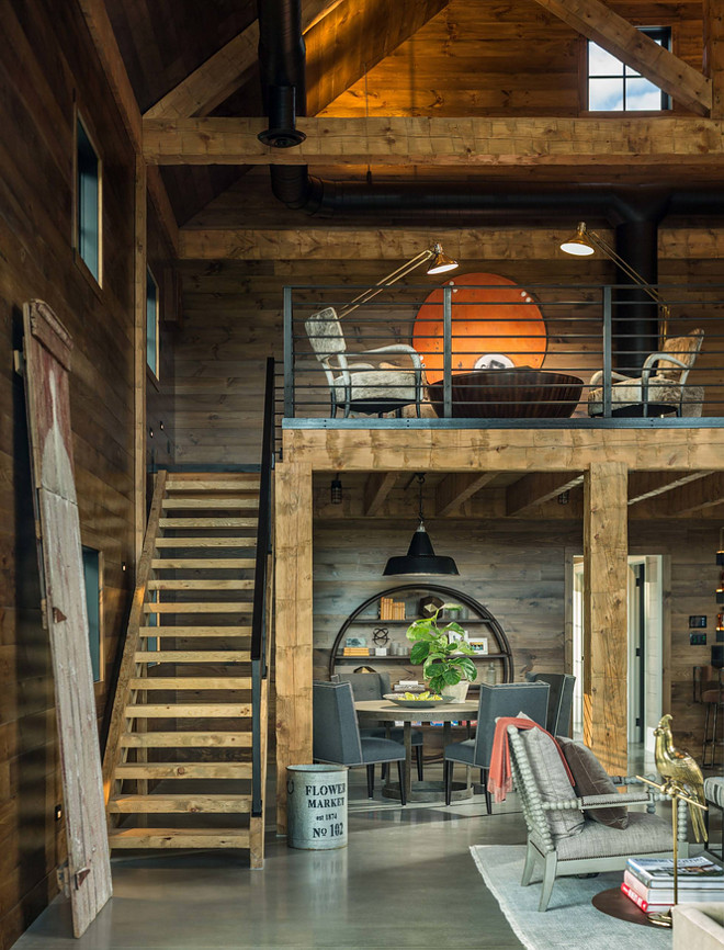 Barn Farmhouse. Rustic barn farmhouse with loft, reclaimed wood shiplap walls, exposed beams, vaulted ceilings, barn lighting and wood and metal stairs. Roundtree Construction. TruexCullins Architecture + Interior Design