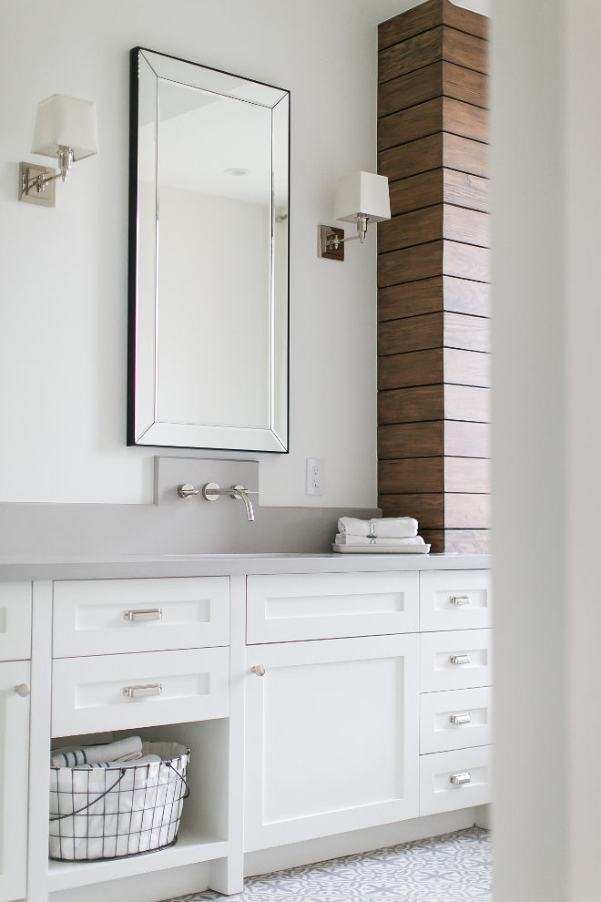 Bathroom with grey quartz countertop, wall-mount faucet, shiplap walls, cement tile and white cabinet. A mirror, from Restoration Hardware, a wall-mounted sink faucet, and the wood stained shiplap accent wall, make of this master bathroom vanity, one special place to get ready in the morning! #Bathroom #greyquartz #greyquartzcountertop #wallmountfaucet #shiplap #shiplapwalls #cementtile #whitecabinet Patterson Custom Homes