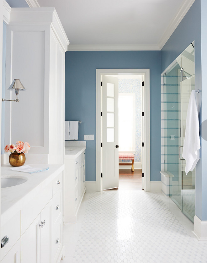 Blue and white bathroom. I love how clean and calm this blue and white bathroom feels. The bathroom is not huge but the designer worked very well with the square footage of this space. Tiles are from New Ravenna. Sconces are by Circa Lighting. Blue and white master bathroom. #Blueandwhitemasterbathroom #bathroom #masterbathroom Andrew Howard Interior Design