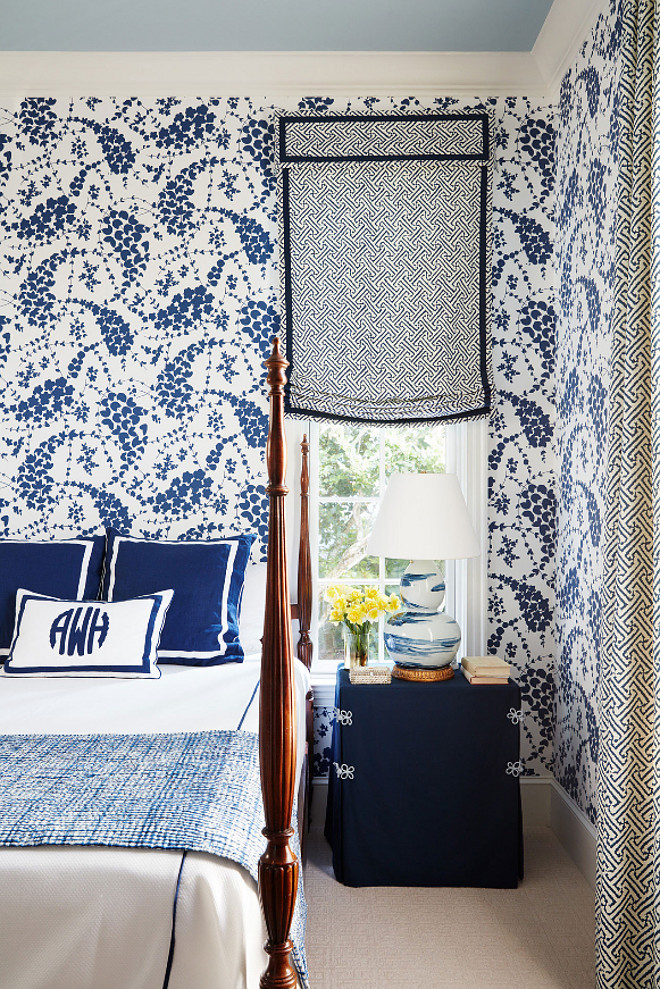 Blue and white bedroom. Bold Blue and white bedroom. Blue and white bedroom wallpaper. Blue and white bedroom wallpaper and blue ceiling. This guest bedroom is bold and chic. The window shade features a Quadrille's fabric - Java Grande. Wallpaper is also Quadrille. The blue and white lamp is from Bunny Williams Home. #Blueandwhitebedroom #Blueandwhitewallpaper #blueceiling #boldinteriors Andrew Howard Interior Design