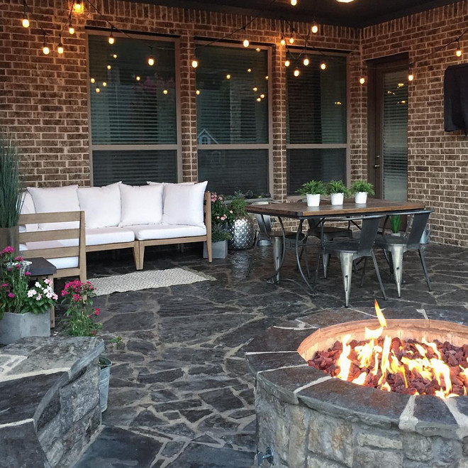 Brick home with industrial inspired porch and outdoor firepit. Home Bunch's Beautiful Homes of Instagram Pillow Thought
