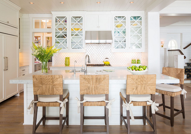 Coastal kitchen with crossed x upper cabinets and shiplap walls.