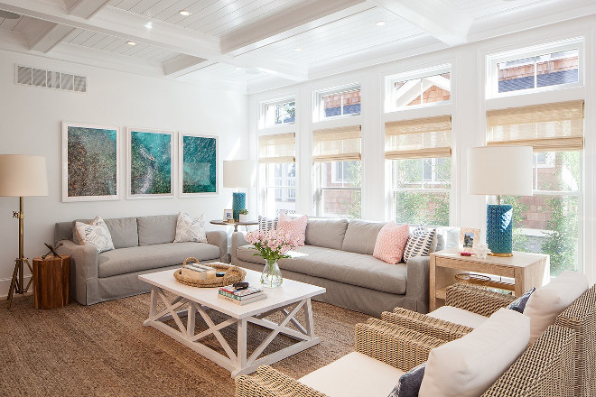 Coastal living room with large chunky jute rug, coffered ceiling, bamboo window shades and pastel colors. Victoria Balson Interiors