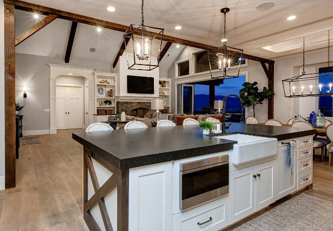 Farmhouse Kitchen Island Design. Farmhouse Kitchen Island. Farmhouse Kitchen Island with thick lathered granite countertop and walnut X Side Panels. White Farmhouse island with walnut X Side Panels. #farmhousekitchenisland #farmhouseisland #walnutXSidePanels #thicklatheredgranitecountertop #thickgranitecountertop #latheredgranitecountertop #latheredcountertop Timberidge Custom Homes