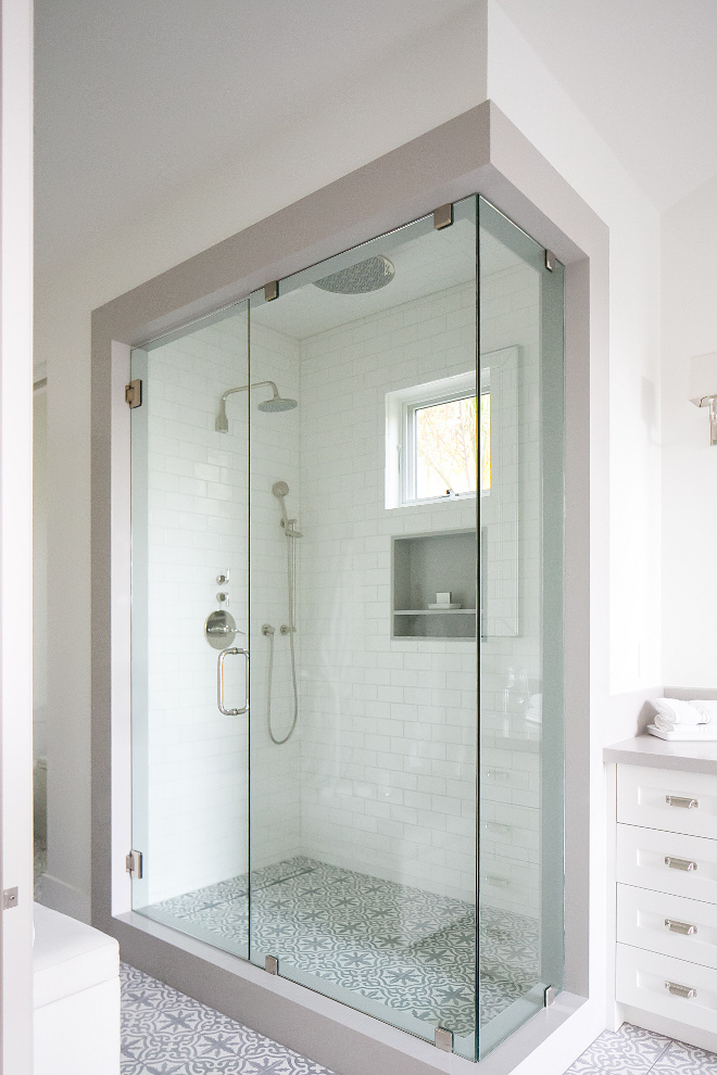 Bathroom frameless glass shower door. This bathroom features a frameless glass shower door and accompanying panel 1/2" thick fully enclosed by a shower jamb that matches the stone at the bathroom's vanity. #Bathroom #framelessglassshowerdoor #glassshowerdoor Patterson Custom Homes