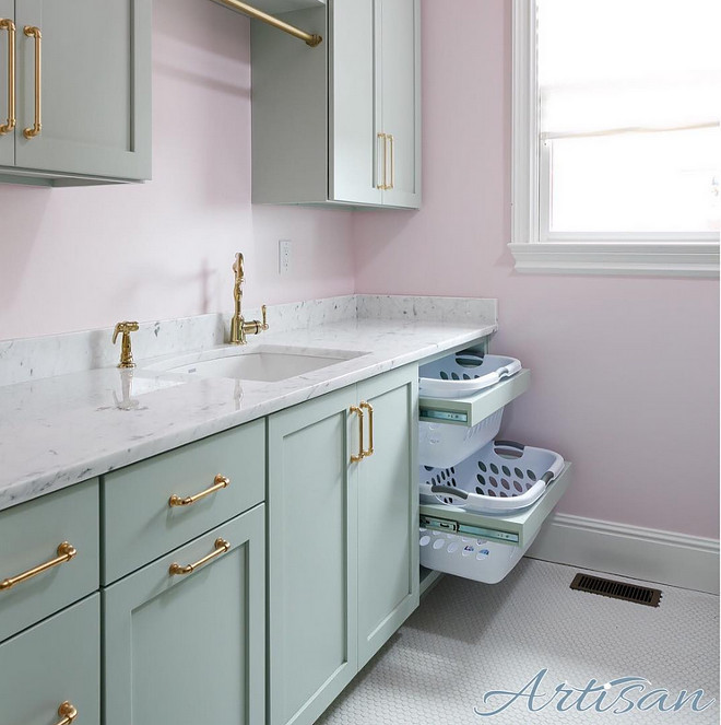 Laundry room. Pale pink walls, turquoise cabinets and brass hardware make for a great laundry room. 