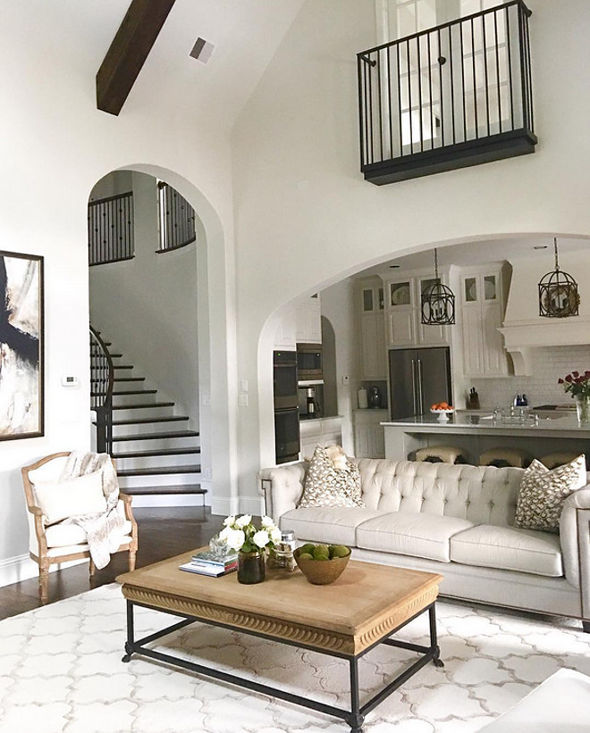 Living room furniture. This grey living room with vaulted ceiling opens to a white kitchen trough an archway. Living room furniture. Living room furniture #Livingroomfurniture #Livingroom #furniture Beautiful Homes of Instagram: classicstylehome